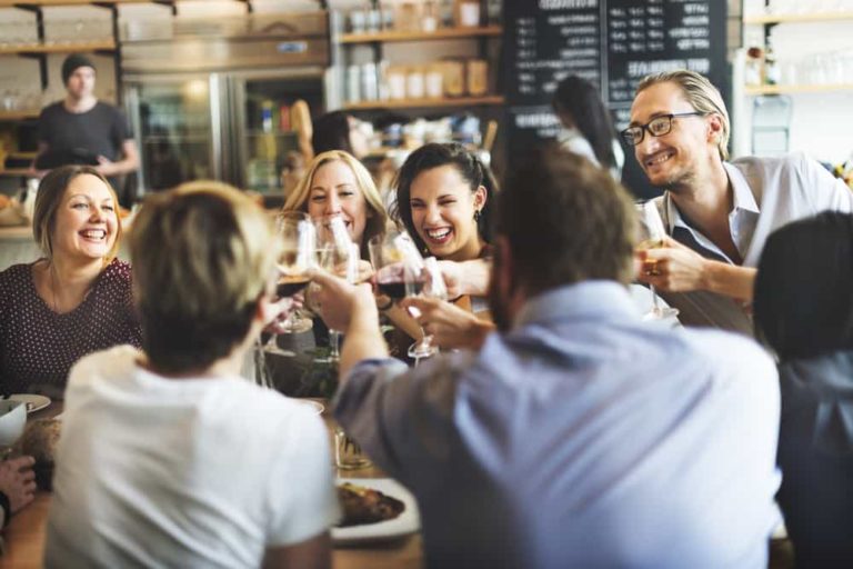 a photo of happy people toasting at a successful restaurant