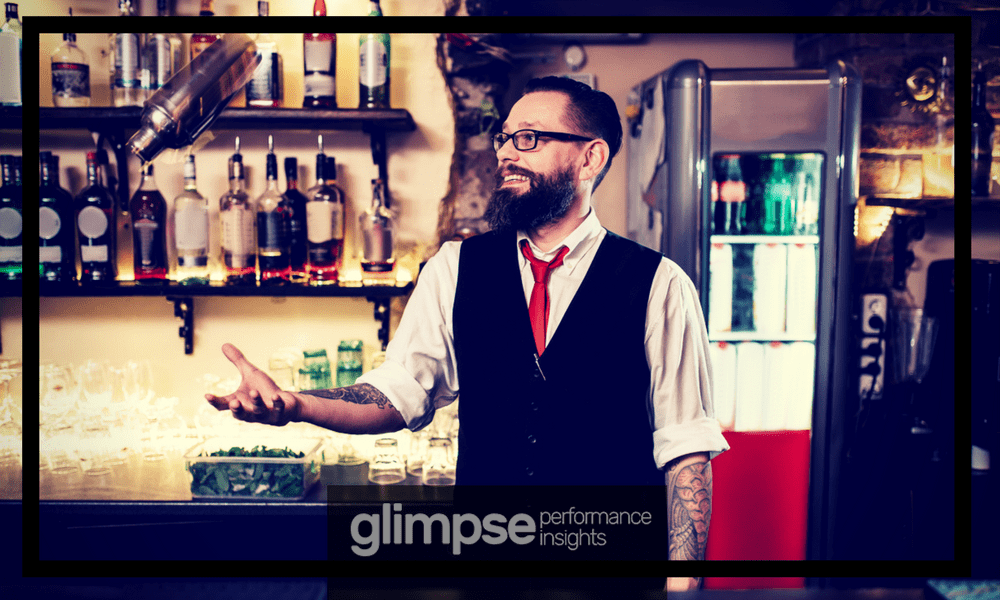 Image of bartender at a bar in Miami mixing a cocktail.