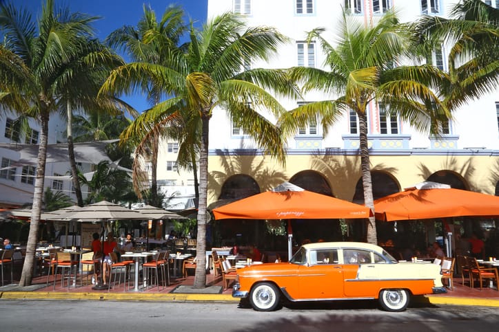 Outside a bar in Miami Beach. Vintage car parked outside of bar.