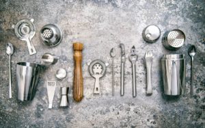 Bar tools for making cocktail. Shaker, jigger, strainer, spoon. Food and beverages. Vintage style toned picture